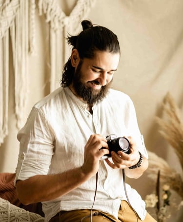 Bonjour Mrs Bride — smiling photographer looking at a vintage film camera in Provence