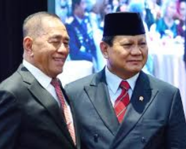 two men in suits and ties standing next to each other