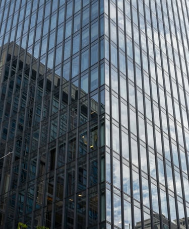 Modern abstract architectural detail of a glass building in a Brazilian financial center, representing corporate strength and legal security.