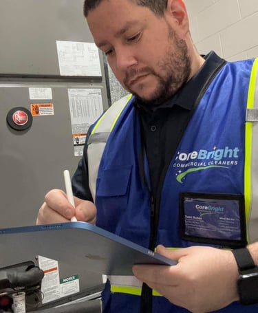 Maintenance worker in blue vest working hear hvac unit