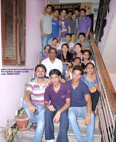 a group of people sitting on stairs with a man in a purple shirt