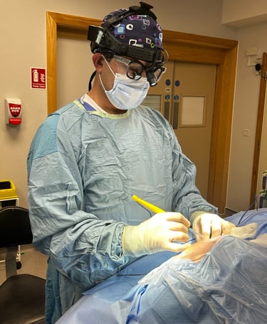 a man in a surgical gown is performing a surgery procedure