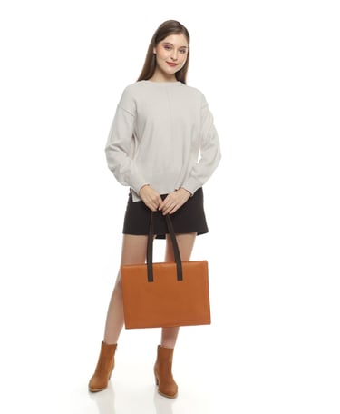 a woman in brown boots and brown totebag