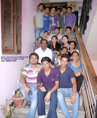 a group of people sitting on stairs with a man in a purple shirt