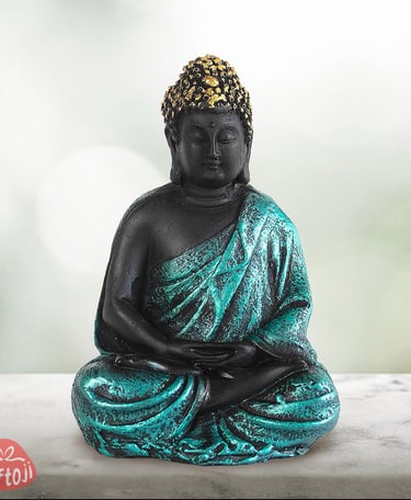 a statue of a buddha statue sitting on a table