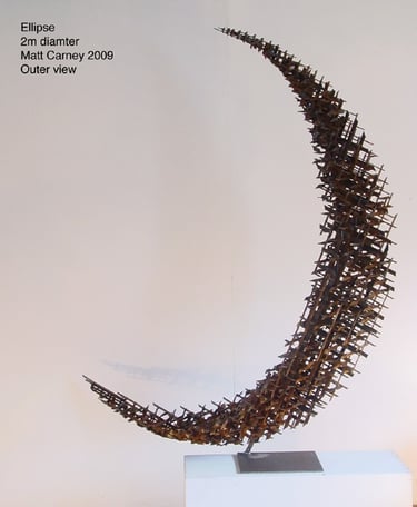 a rusted steel cross-hatched crescent shaped sculpture