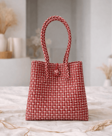 Handwoven red striped plastic tote bag handmade from recycled materials by Indonesian artisans