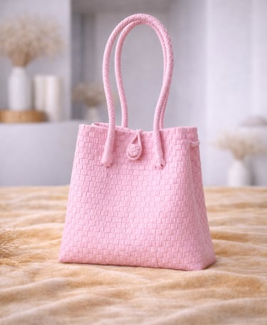 Handwoven soft pink plastic tote bag handmade from recycled materials by Indonesian artisans