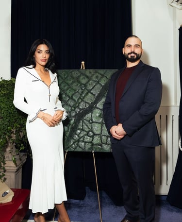 a man and woman standing in front of a painting