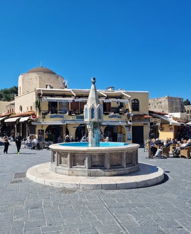 a fountain fountain in a square in a town