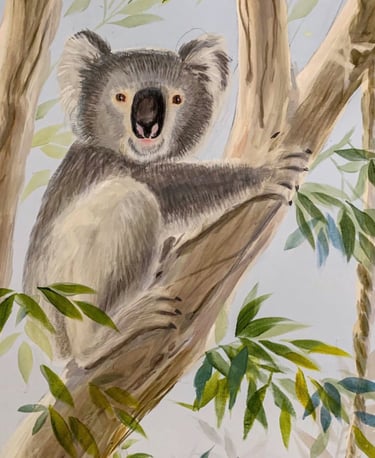Hand-painted koala resting in a gum tree — Australian nursery mural detail in calm neutral tones.