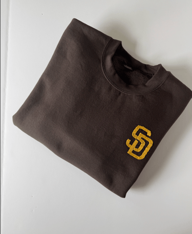 a brown San Diego Padres sweatshirt with the SD logo embroidered in golden yellow