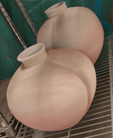 large wheel-thrown vases, altered by paddling, spray glazed and waiting for high fire
