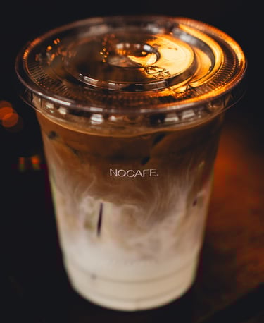 a cup of coffee with a candle on a table