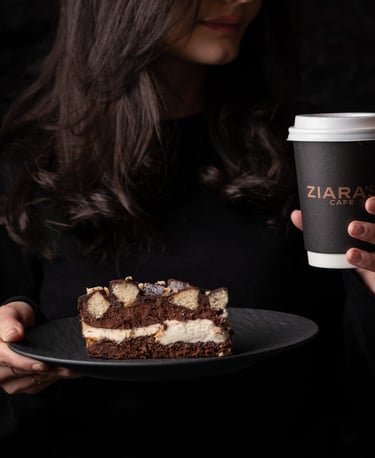 woman eating a dessert and drinking coffee