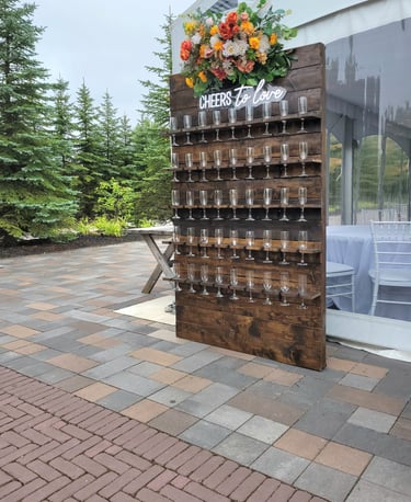 Custom made brown stained champagne wall for an outdoor wedding with fall florals
