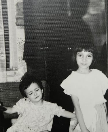 a little girl pushing another girl from the frame