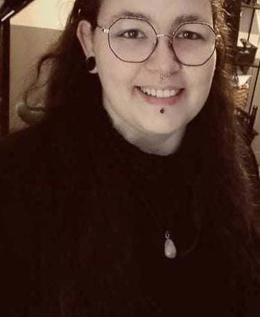 Moi, la créatrice de ce site, de cette marque. Souriante, habillée de noir avec un collier en pierre