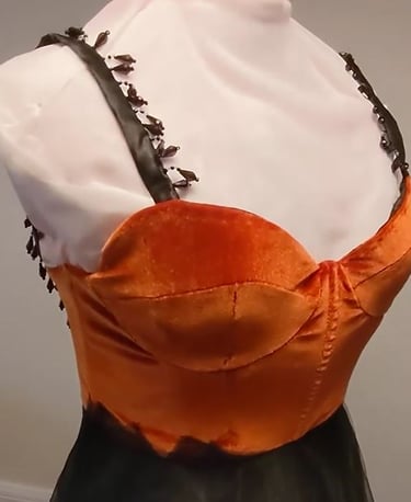 A burnt orange velvet sweetheart neckline dress with beaded black straps