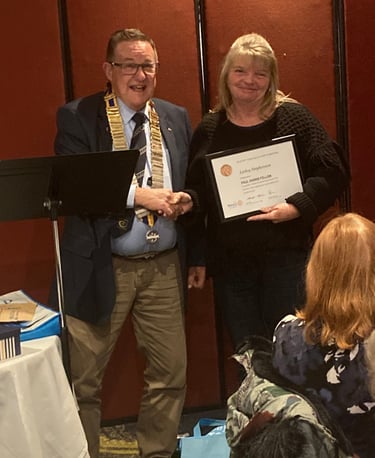 2024 President Rod presents Lesley Stephens from Bunnings Fyshwick with the Paul Harris Fellow award