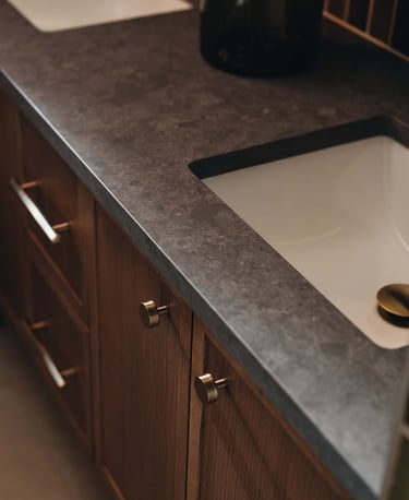 a bathroom sink with a black counter top