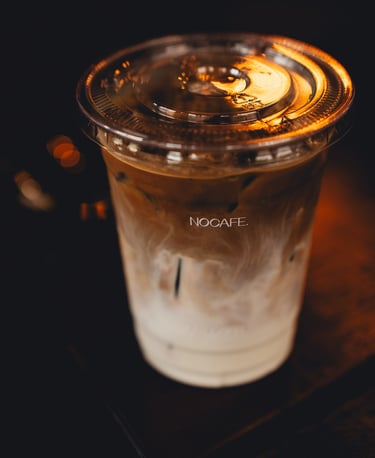 a cup of coffee with a candle on a table