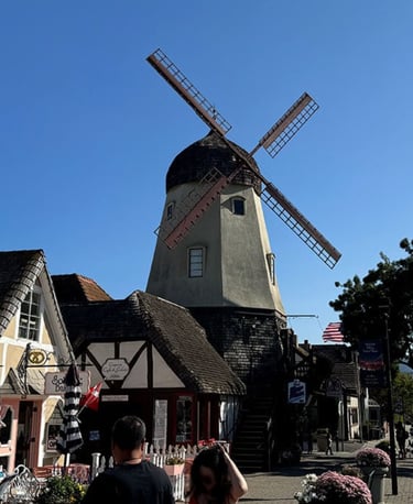 Downtown Solvang windmill and Danish-style buildings in Solvang, California on a sunny day