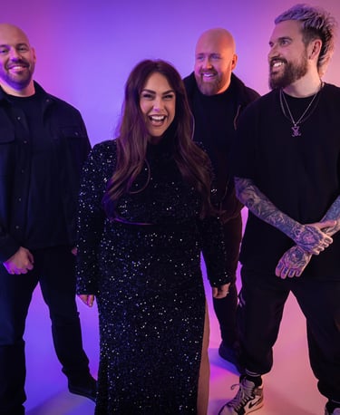 a group of people standing around a woman in a black dress