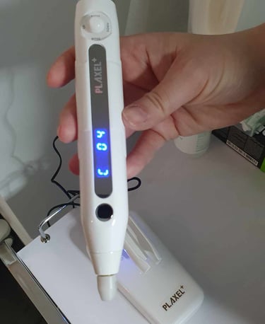 a person holding a PLAXEL PLUS device