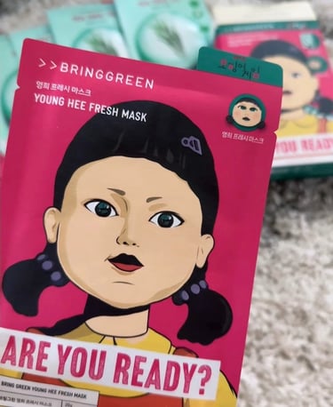 Bring Green Young Hee Fresh Mask sheet featuring the iconic Squid Game doll character on pink packaging.