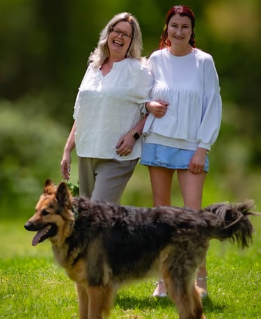 This image portrays a warm, candid moment outdoors featuring two people walking arm in arm. Athens