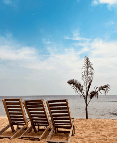 two empty chairs sitting on a Coco beach Entebbe