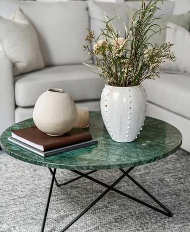 Neutral living room with large woven area rug under sofa and a coffee table