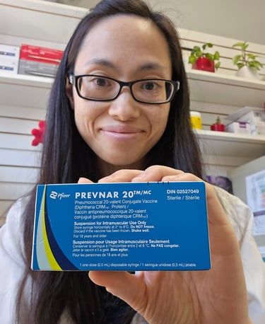 Pharmacist Linda Nghiem holding a prevnar 20 blue box
