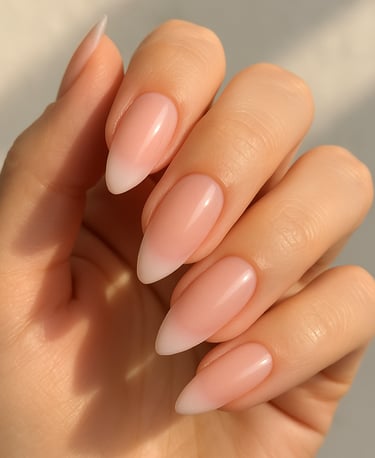 almond-shaped nails, soft blush pink sheer base, barely-there pink ombré French tips