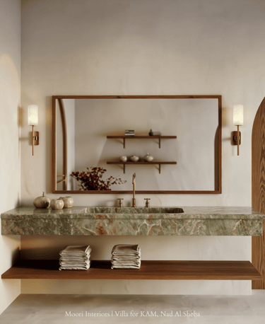Green onyx vanity with wood accents and ambient wall sconces in luxury bathroom.