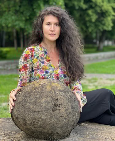 Facilitator holding a heavy stone as a metaphor for chronic constipation & emotional release