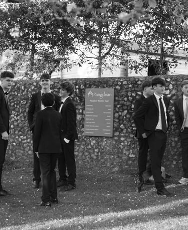 black and white image of boys standing in the park