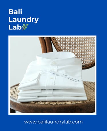 Freshly folded laundry on a wooden chair — clean and eco drop‑off laundry in Renon, Denpasar.