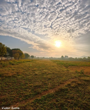 Golden morning sunrise over the grass runway at Go Fly Zone under a dramatic altocumulus cloud sky.