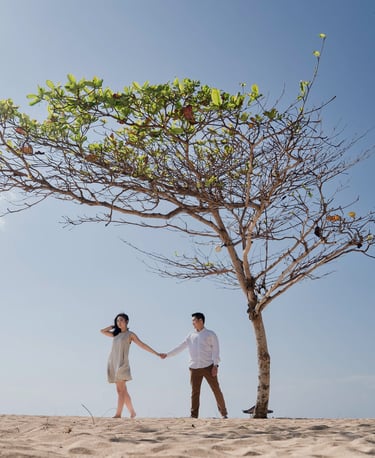 Intimate proposal couple under a lone tree at Sofitel Nusa Dua beach Bali