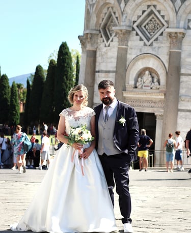 a man and woman standing in front of a church