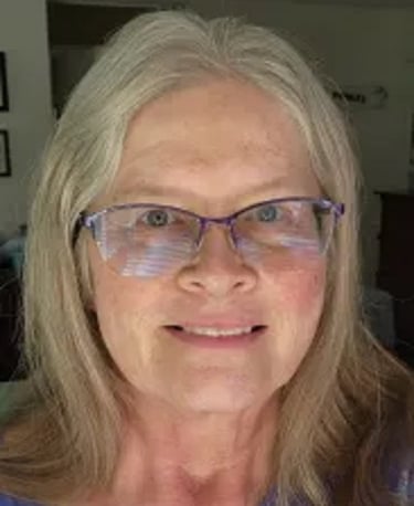Photo of Dawn Standke, a woman with blonde silver hair and glasses
