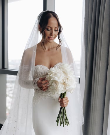 a bride in a white wedding dress with a veil