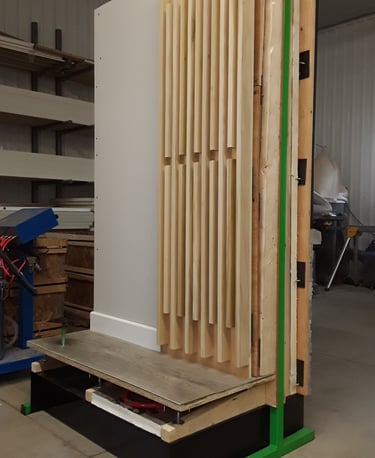 Interior wall mock-up with decorative wood slat paneling and raised flooring system for design and construction display