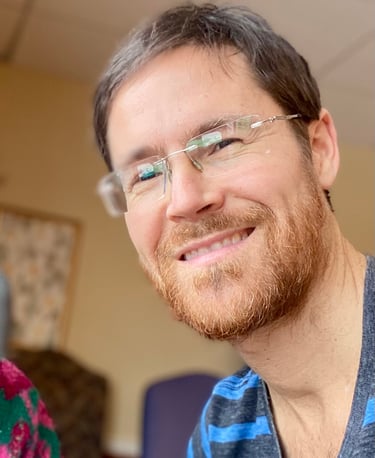 a man with glasses and a striped shirt