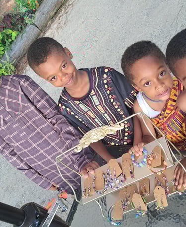 Picture of Four Brothers next to the jewelry they created left to right Ethan, Decklan, Theodore and Mason.