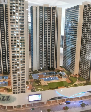 a model of a building with a large building in the background
