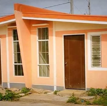 a small house with a red roof and a red door