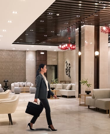a woman walking through a lobby area of a hotel